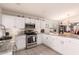 Open kitchen featuring stainless steel appliances, light cabinets and decorative backsplash at 3403 E Kristal Way, Phoenix, AZ 85050