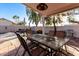 Covered patio with dining set and BBQ, perfect for outdoor entertaining in a private backyard at 3403 E Kristal Way, Phoenix, AZ 85050