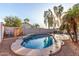 Backyard pool with tanning ledge, privacy fence, rock landscaping, and patio furniture at 3403 E Kristal Way, Phoenix, AZ 85050