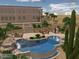Exterior view of backyard swimming pool with waterfall, hot tub, patio and outdoor kitchen set in desert landscape at 36923 N 31St Ave, Phoenix, AZ 85086