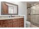 Bathroom featuring a granite vanity, glass enclosed shower, and ceramic tile at 36923 N 31St Ave, Phoenix, AZ 85086