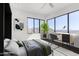 Staged bedroom featuring a modern desk, sleek floors, large windows, and scenic desert views at 36923 N 31St Ave, Phoenix, AZ 85086