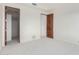 Spacious room featuring neutral carpet and paneled doors at 36923 N 31St Ave, Phoenix, AZ 85086