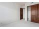 Spacious room featuring neutral carpet and paneled doors at 36923 N 31St Ave, Phoenix, AZ 85086