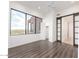 Spacious bedroom with laminate floors, large windows, and a sliding barn door to the walk-in closet at 36923 N 31St Ave, Phoenix, AZ 85086