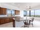 Well-lit kitchen with granite countertops, kitchen island, breakfast bar seating, and desert views at 36923 N 31St Ave, Phoenix, AZ 85086
