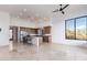 Open-concept living area with kitchen island, stainless appliances, recessed lighting, tile floors, and scenic window views at 36923 N 31St Ave, Phoenix, AZ 85086