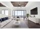 Bright living room with floor to ceiling windows showcasing a beautiful outdoor view and sophisticated decor at 36923 N 31St Ave, Phoenix, AZ 85086