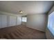 Large bedroom with plush carpeting, ample closet space, and bright natural lighting at 4424 E Pueblo Ave, Phoenix, AZ 85040