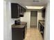 Well-lit kitchen featuring brown cabinets, countertops, and appliances, complemented by tiled flooring at 4424 E Pueblo Ave, Phoenix, AZ 85040