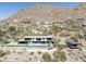 Aerial view of an incredible modern home with a pool, putting green, and mountain backdrop at 4725 N 56Th St, Phoenix, AZ 85018