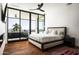 Modern bedroom featuring a spacious balcony, hardwood floors, a ceiling fan, and natural light at 4725 N 56Th St, Phoenix, AZ 85018