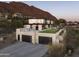 Modern home exterior features a garage rooftop patio, sleek design, and desert views at 4725 N 56Th St, Phoenix, AZ 85018