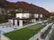 Luxury modern home exterior showcasing a putting green, grill, and mountain views at 4725 N 56Th St, Phoenix, AZ 85018