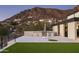 Home exterior showcasing an outdoor kitchen, putting green, and mountain views at 4725 N 56Th St, Phoenix, AZ 85018