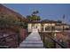 Dusk view of modern property featuring an exterior walking bridge with views of palm trees and mountain at 4725 N 56Th St, Phoenix, AZ 85018