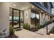 Modern home's front entrance with sleek black framed door and large windows, showcasing a contemporary design at 4725 N 56Th St, Phoenix, AZ 85018