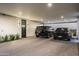 Open garage area featuring two black SUVs parked on a stone-paved drive at 4725 N 56Th St, Phoenix, AZ 85018