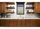 Close-up of a kitchen with wood cabinets, marble countertops, and a view of the mountains at 4725 N 56Th St, Phoenix, AZ 85018