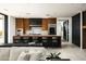 Gourmet kitchen featuring a large island, bar seating, modern appliances, and sleek wooden cabinetry at 4725 N 56Th St, Phoenix, AZ 85018