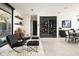 Living room featuring modern leather chairs, shelving, and a glass-enclosed wine storage room at 4725 N 56Th St, Phoenix, AZ 85018