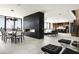 Spacious open-concept living room with a modern fireplace, dining area, and views of the city at 4725 N 56Th St, Phoenix, AZ 85018
