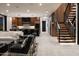 Spacious open-plan living room featuring a kitchen, modern staircase, and comfortable seating at 4725 N 56Th St, Phoenix, AZ 85018