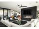 Bright living room with a modern fireplace, black leather chairs, and a white couch near sliding doors at 4725 N 56Th St, Phoenix, AZ 85018