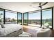 Bright bedroom has floor-to-ceiling windows showcase views of the yard and mountains with comfortable seating area at 4725 N 56Th St, Phoenix, AZ 85018