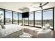 Sunlit main bedroom boasts expansive windows with stunning city views, plus cozy seating and a modern ceiling fan at 4725 N 56Th St, Phoenix, AZ 85018