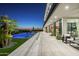 Modern patio featuring an infinity pool, outdoor seating, and lush landscaping at 4725 N 56Th St, Phoenix, AZ 85018