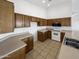 Clean kitchen with ample cabinet space, white appliances, and tile countertops at 4824 W Saint John Rd, Glendale, AZ 85308