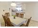 Bright dining room features a table with seating for six and view into the kitchen at 5515 W Minnezona Ave, Phoenix, AZ 85031