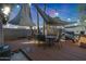 Backyard deck with shade sails, grill, and outdoor dining area at 556 W Kiva Ave, Mesa, AZ 85210