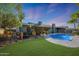 An additional view of the refreshing pool showcasing the lush greenery and privacy of the backyard at 556 W Kiva Ave, Mesa, AZ 85210