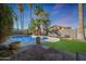 Inviting backyard with a refreshing pool, patio and lush landscaping, perfect for outdoor relaxation and entertainment at 556 W Kiva Ave, Mesa, AZ 85210