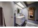 Updated bathroom features a framed mirror, modern vanity, and stylish fixtures at 556 W Kiva Ave, Mesa, AZ 85210