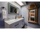 Stylish bathroom vanity with mosaic mirror and decorative gold mirror at 556 W Kiva Ave, Mesa, AZ 85210