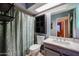 Well-maintained bathroom with a vanity, framed mirror, and shower with curtain at 556 W Kiva Ave, Mesa, AZ 85210