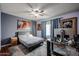 Comfortable bedroom with a neutral palette, ceiling fan, glass desk and stylish decor at 556 W Kiva Ave, Mesa, AZ 85210