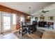 Dining room with brick wall, traditional table, and patterned rug at 556 W Kiva Ave, Mesa, AZ 85210