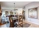 Spacious dining area featuring a large wooden table, decorative rug, and ample natural light at 556 W Kiva Ave, Mesa, AZ 85210