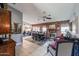 Open-concept living/dining area with tile floors, fireplace, and views of the modern kitchen at 556 W Kiva Ave, Mesa, AZ 85210