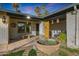 Inviting front porch with seating, potted plants, and charming decorative accents at 556 W Kiva Ave, Mesa, AZ 85210