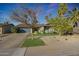 Charming single-story home with well-maintained lawn and a driveway at 556 W Kiva Ave, Mesa, AZ 85210