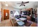 Cozy living room features a TV, ceiling fan, and a comfortable sofa at 556 W Kiva Ave, Mesa, AZ 85210