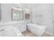 Luxurious bathroom features double sinks, a soaking tub, and pristine white finishes for a spa-like experience at 5741 E Star Valley St, Mesa, AZ 85215