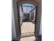 Metal gate with access to the courtyard with stone pavers and view to the front of the house at 5741 E Star Valley St, Mesa, AZ 85215