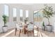 Elegant dining room with a circular table, stylish chairs, and large windows showcasing a view of the outdoors at 5741 E Star Valley St, Mesa, AZ 85215