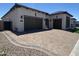 Beautiful single-story home boasts a paver driveway, two-car garage, and well-manicured landscaping at 5741 E Star Valley St, Mesa, AZ 85215